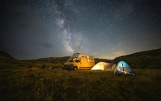 A collection of lightweight camping tents set up in a scenic landscape