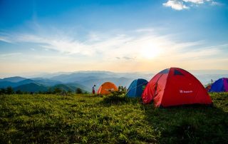 A lightweight camping tent set up in a scenic outdoor location