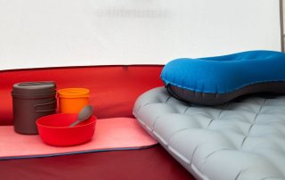 A self-inflating camping tent set up in a scenic outdoor location
