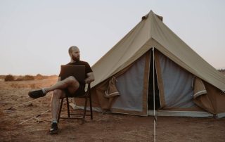 A variety of modern camping tents set up in nature