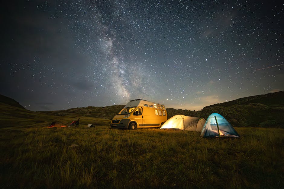 Various camping tents set up in a beautiful natural landscape
