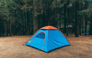 Various camping tents set up in a scenic outdoor environment.